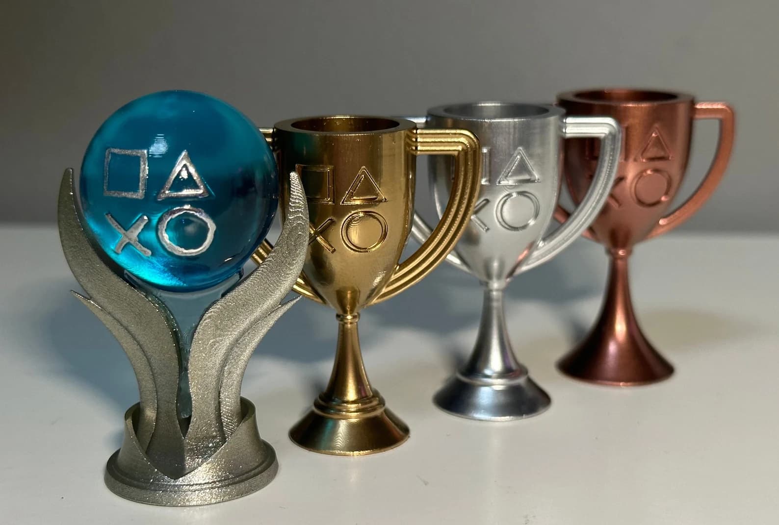 A collection of 3D-printed PlayStation trophies