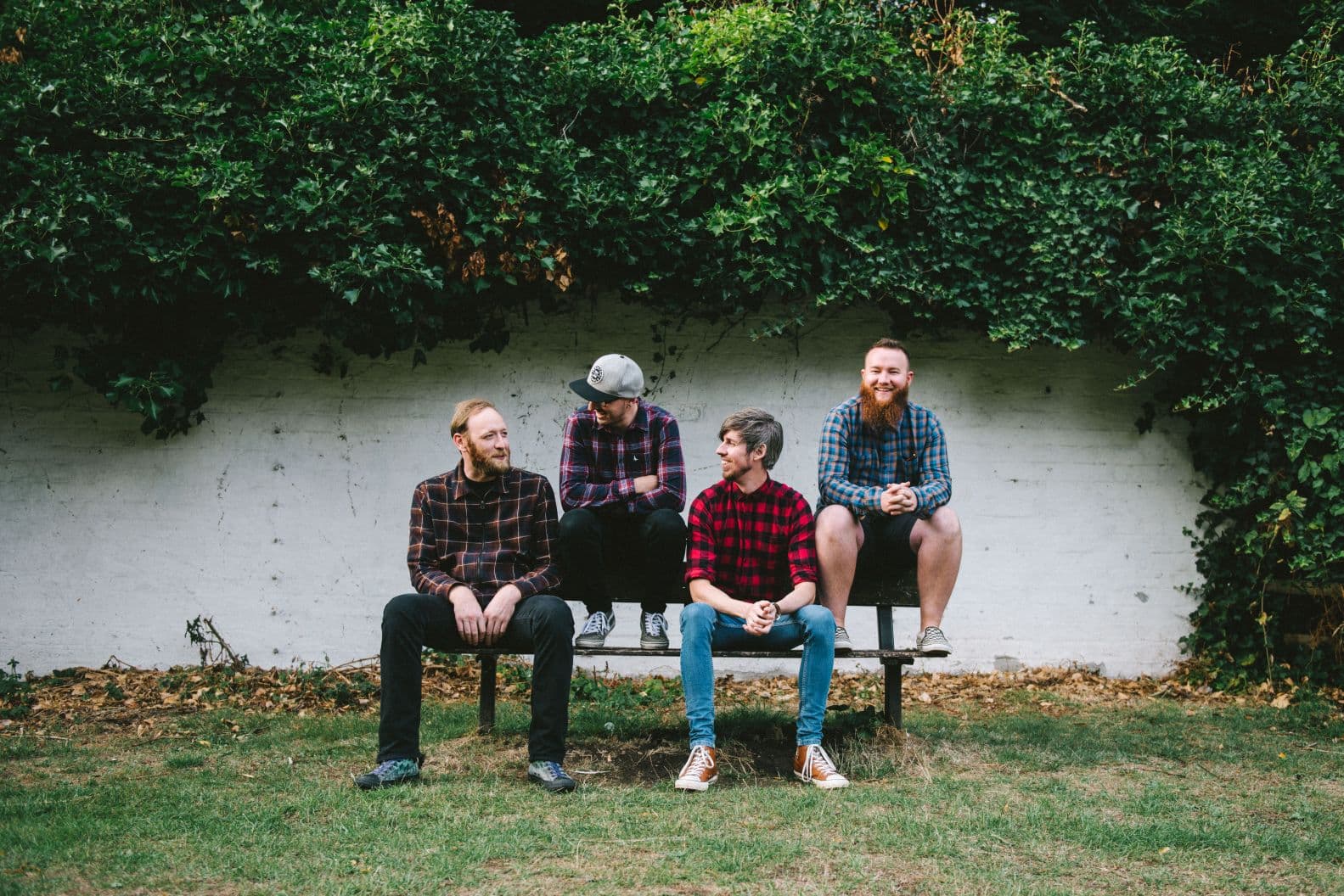 The band Amateur Ghost sat on a park bench