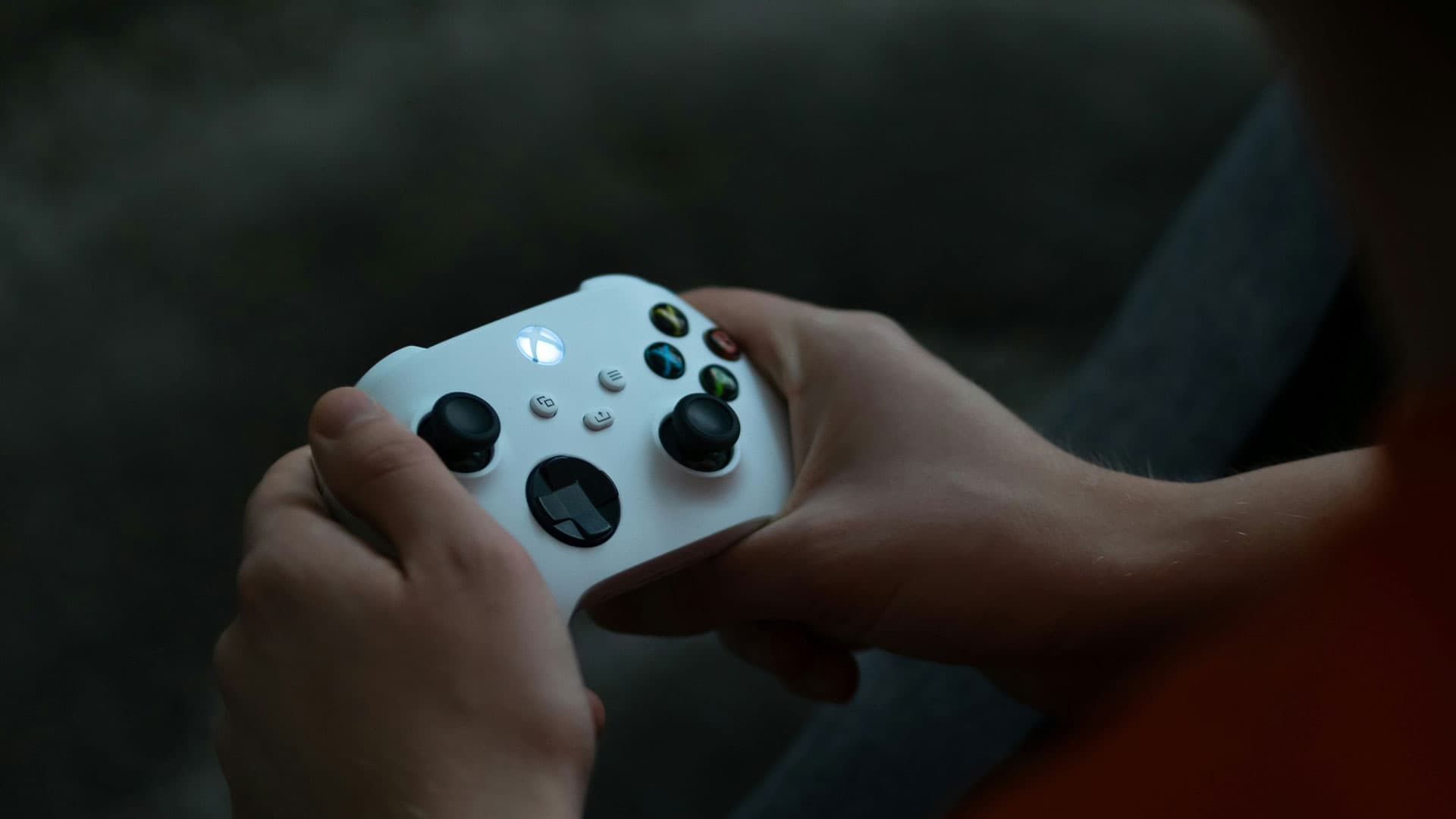 Man holding white Xbox controller